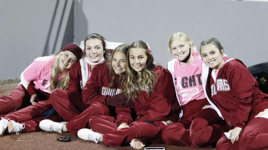 Conestoga cheerleaders take a breather during halftime of the football game against Brownell Talbot. The cheer team is a constant positive presence at CHS sporting events. 