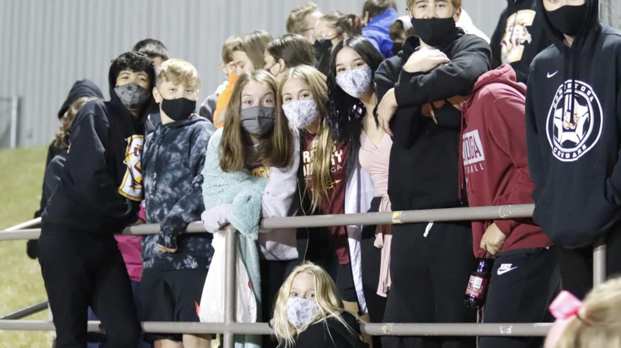 Conestoga students stay masked up as they cheer on the Cougars during the homecoming game.