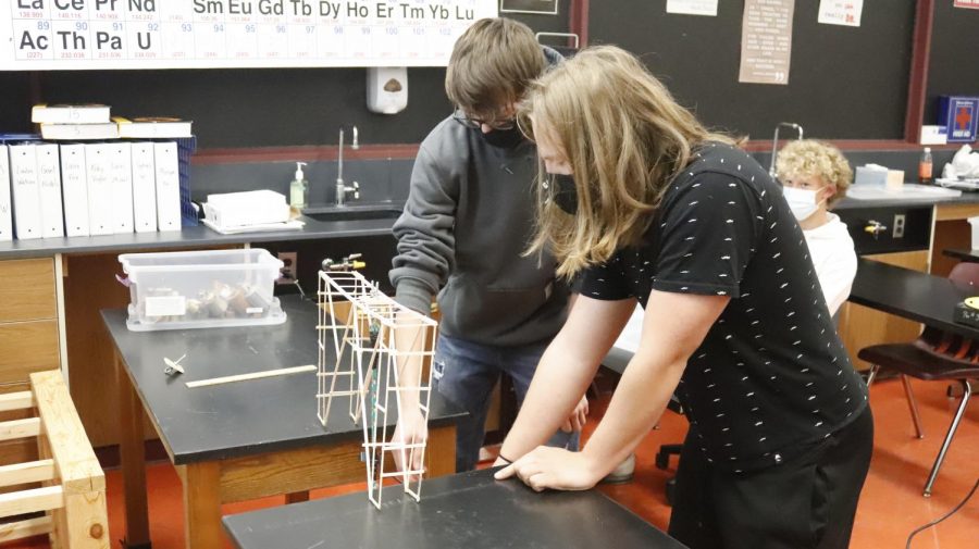 Juniors+Jake+Heronimus+and+Gabe+Turner-Hickey+examine+the+bridge+they+created+in+Mr.+Huskeys+Physics+Class.+With+extended+class+periods%2C+students+are+able+to+make+the+most+of+their+hands-on+learning+projects.
