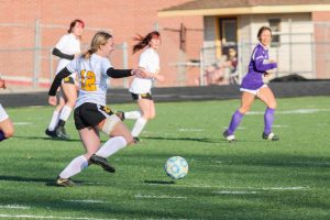 Mati Steckler (Jr.) cheerfully navigates her way through the Nebraska City defense in an April 1 contest against the Pioneers.