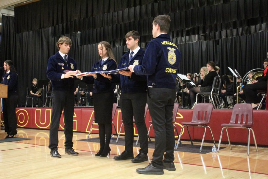 FFA+Students+fold+the+American+flag+during+the+Veterans+Day+program.