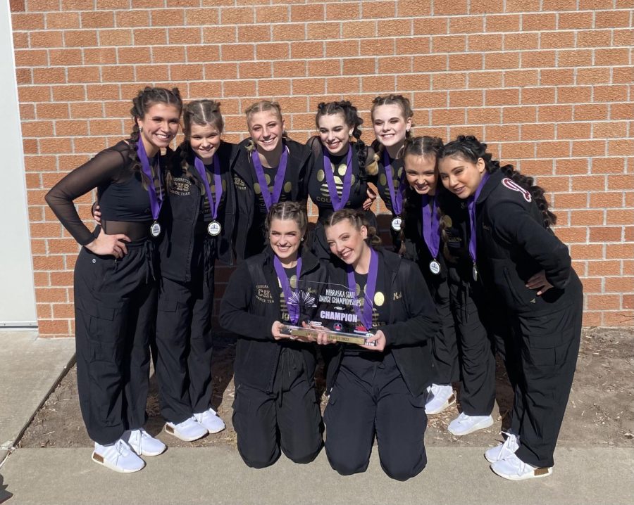 The dance team poses with their state championship hardware.