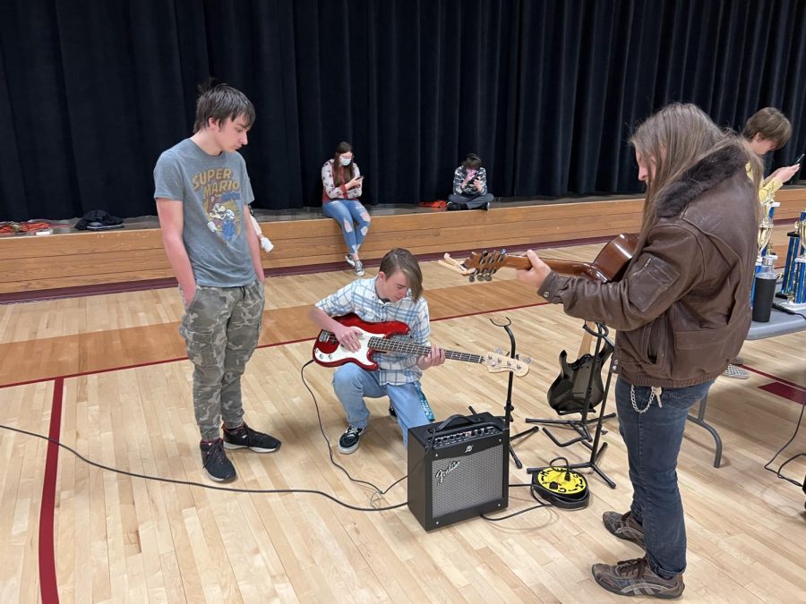 Students play the guitars at the music booth
