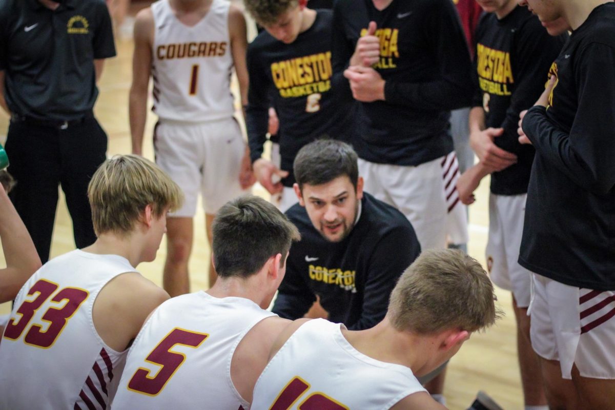 Head coach Jason Ahrens addresses the boys' basketball team during a game. He will now be teaching some of those players as he transitions back to teaching from being the activities director.